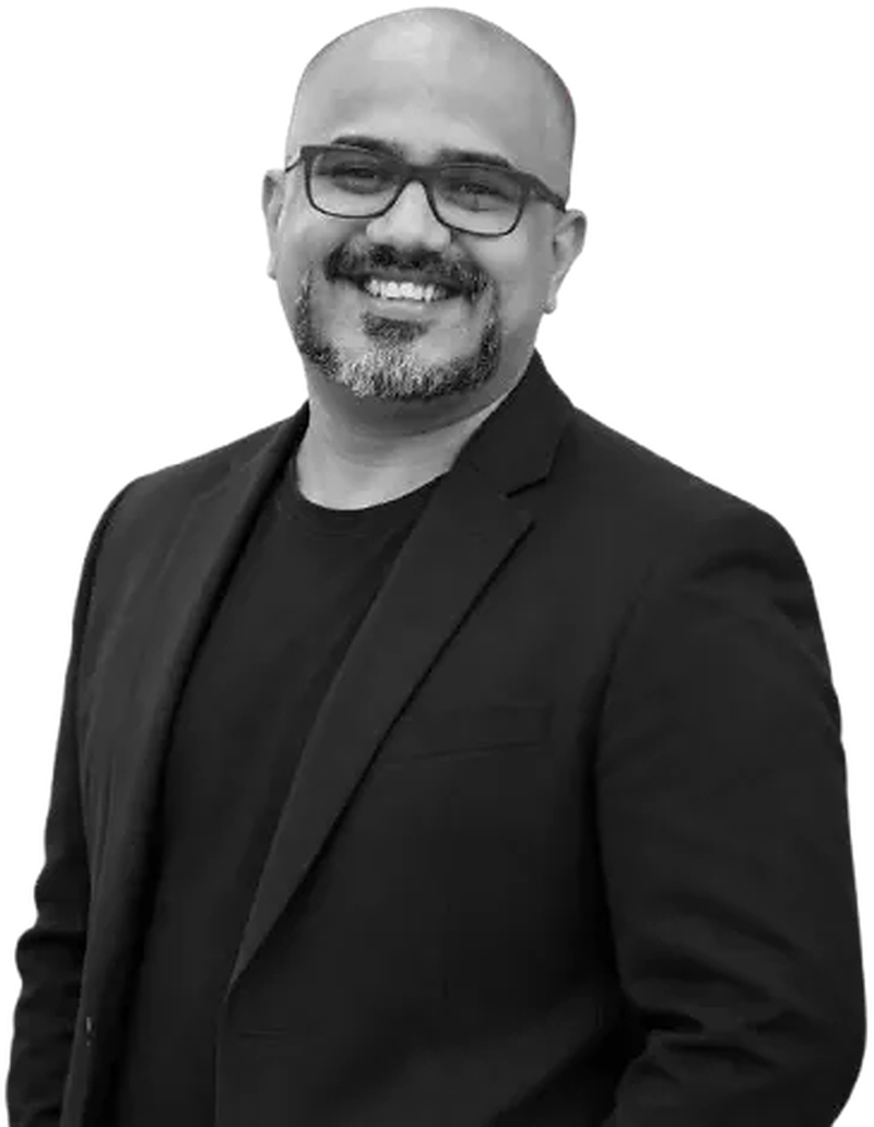 Dr. Aashutosh, accessibility consultant, smiling in glasses and a dark blazer