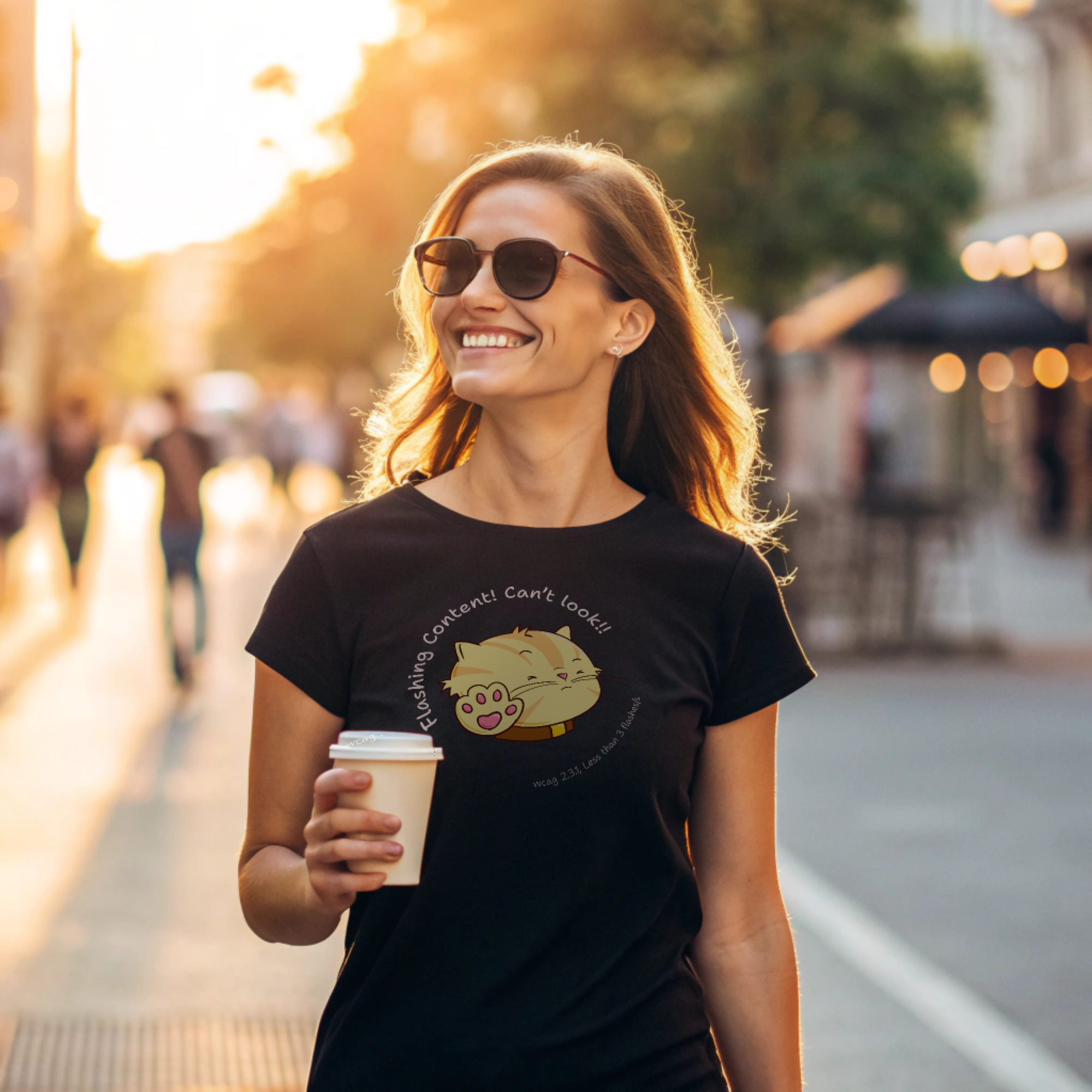 Person walking on a sunny street wearing a black t-shirt with a cartoon cat and the text 'Flashing Content! Can't look!!' referencing WCAG 2.3