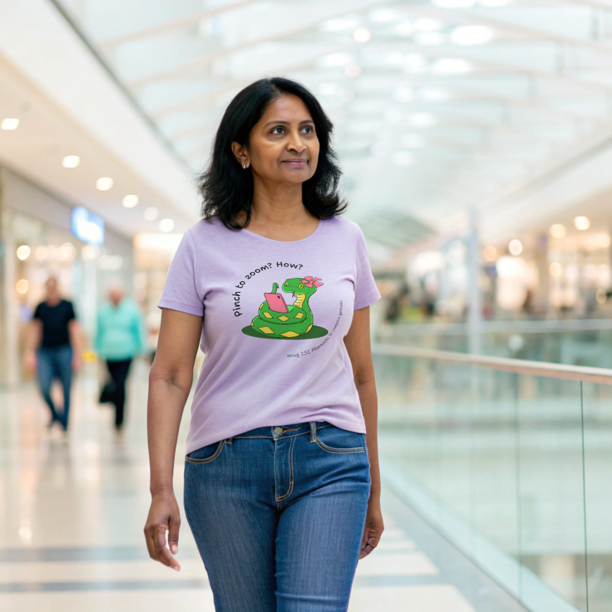 Woman walking in a mall wearing a purple t-shirt with a cartoon snake and the text 'Pinch to zoom? How?' referencing WCAG 2.5.1